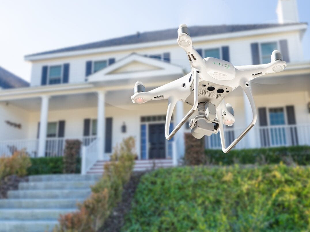Drone inspecting the exterior of a home as part of a modern home inspection.