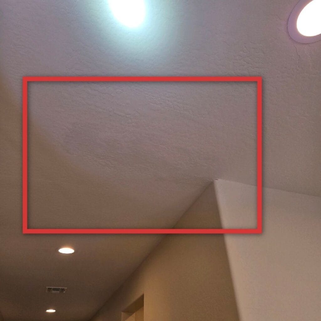 Previously repaired ceiling showing signs of past water damage and possible hidden signs of black mold